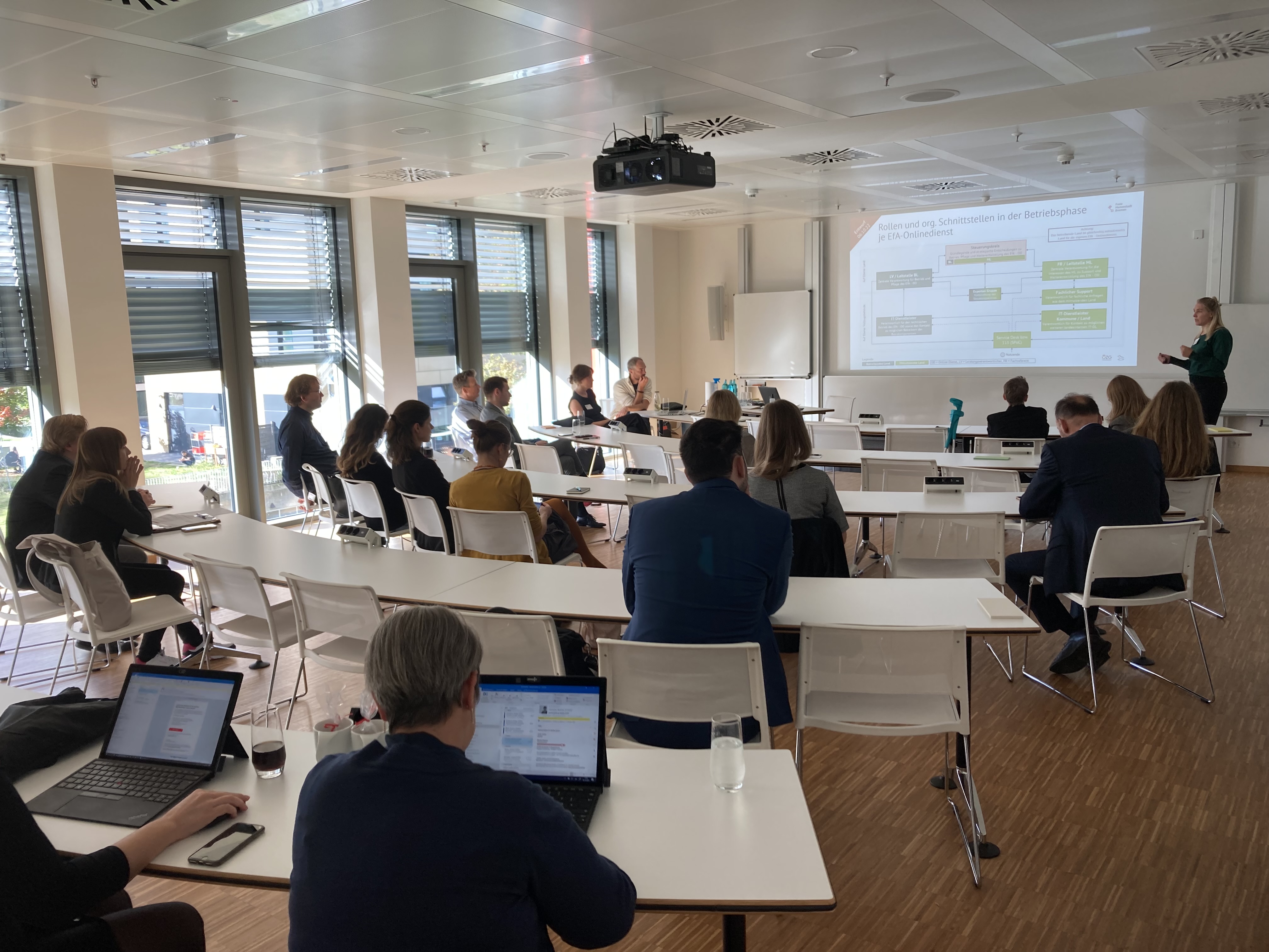 Teilnehmende hören einem Referenten zu